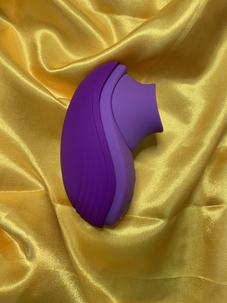 Fantasy for Her, Her Silicone Fun Tongue is a purple toy pictured on yellow satin. The toy is painfully gendered, in both search terms think: "female massager" and in marketing and name