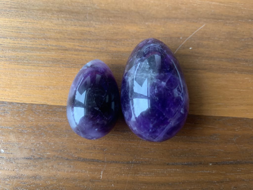 amethyst crystal yoni eggs are pictured side-by-side. The eggs gave me a yeast infection because I didn't wash them carefully enough