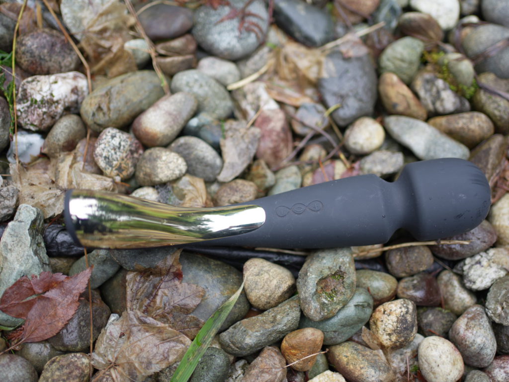 The Lelo Wand 2 sits on a bed of rocks