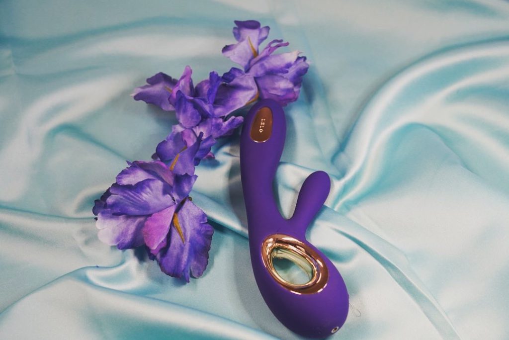 The soraya wave is a rabbit g-spot fingering vibrator. It is a deep blue with a gold handle.