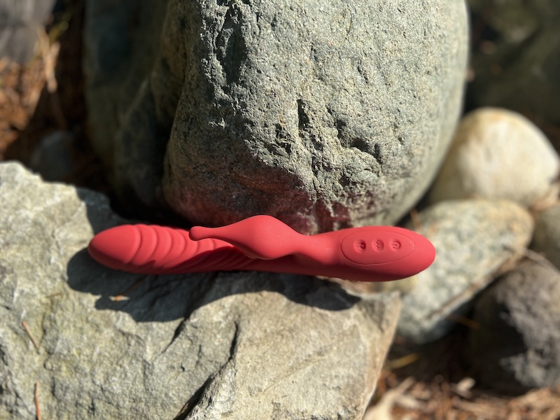 Bestvibe Heating Licking Rabbit vibrator  rests on a rock at a pond